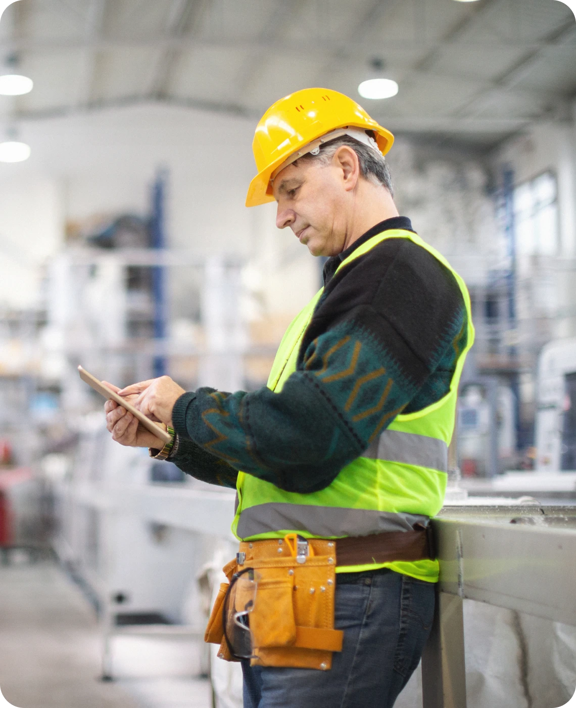 Worker in hard hat using tablet