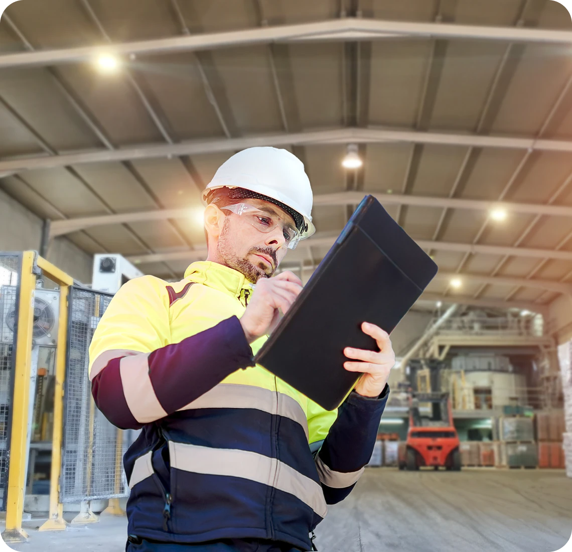 Man in safety gear checking tablet